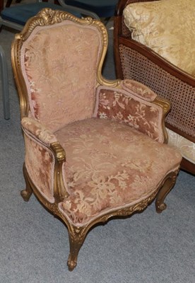 Lot 1254 - A Victorian gilt and carved armchair, upholstered in floral cut velvet, 57cm wide