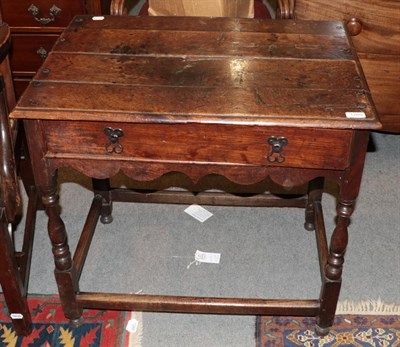 Lot 1269 - An early 18th century oak side table with a single drawer, wavy shaped apron and baluster legs,...