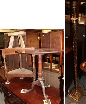 Lot 1297 - A George III mahogany tripod table; a 20th century oak corner table; a brass spiral turned standard