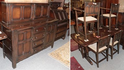 Lot 1300 - A mid 20th century oak dining room suite comprising: sideboard; trestle based table; six chairs...