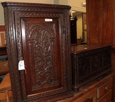 Lot 1302 - A Victorian carved oak corner cupboard; together with an early 20th century carved oak blanket...