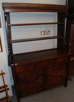 Lot 1319 - An 18th century oak dresser, the rack with two fixed shelves, the base with three drawers above...