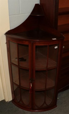 Lot 1321 - An Edwardian mahogany and boxwood strung bow fronted corner cabinet, twin lancet glazed doors