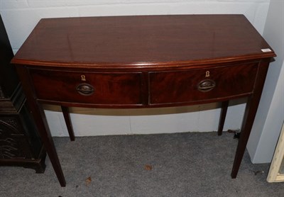 Lot 1329 - A late George III mahogany bow fronted side table, fitted two drawers, 105cm wide