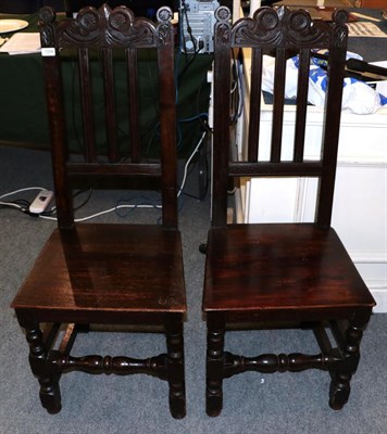 Lot 1334 - A pair of 17th century joined oak hall chairs, with later seats