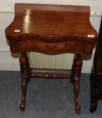 Lot 1335 - A Victorian burr walnut games and sewing table, with sliding work box, 54cm wide