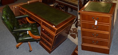 Lot 1364 - A reproduction yew wood pedestal desk; a green button leather executive high back chair; and a...