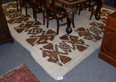 Lot 1369 - A large Moroccan piled carpet, the cream field of stepped geometric motifs, 391cm by 307cm