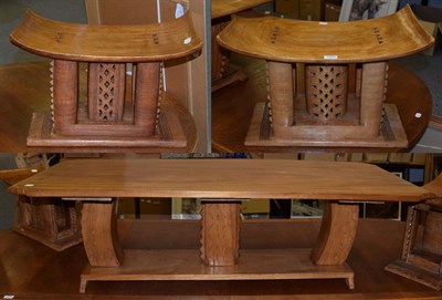 Lot 1379 - An African carved hardwood coffee table, 154cm wide; and a pair of carved oak stools/tables to...