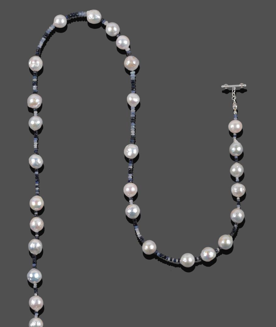 Lot 1000 - A Sapphire and Cultured Pearl Necklace, faceted sapphire beads of varying blue to white tones...