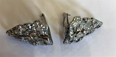 Lot 1002 - An Art Deco Diamond Double Clip Brooch, the geometric form inset with baguette cut, old cut and...