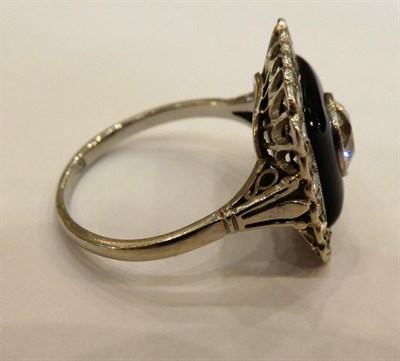 Lot 1008 - An Art Deco Onyx and Diamond Cluster Ring, an old cut diamond centres a square onyx plaque within a