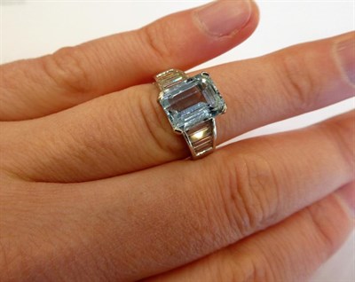 Lot 1010 - An 18 Carat White Gold Aquamarine and Diamond Ring, the emerald-cut aquamarine in a white four claw