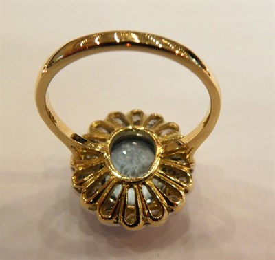 Lot 1017 - An Aquamarine and Diamond Cluster Ring, the oval cut aquamarine in a white rubbed over setting,...