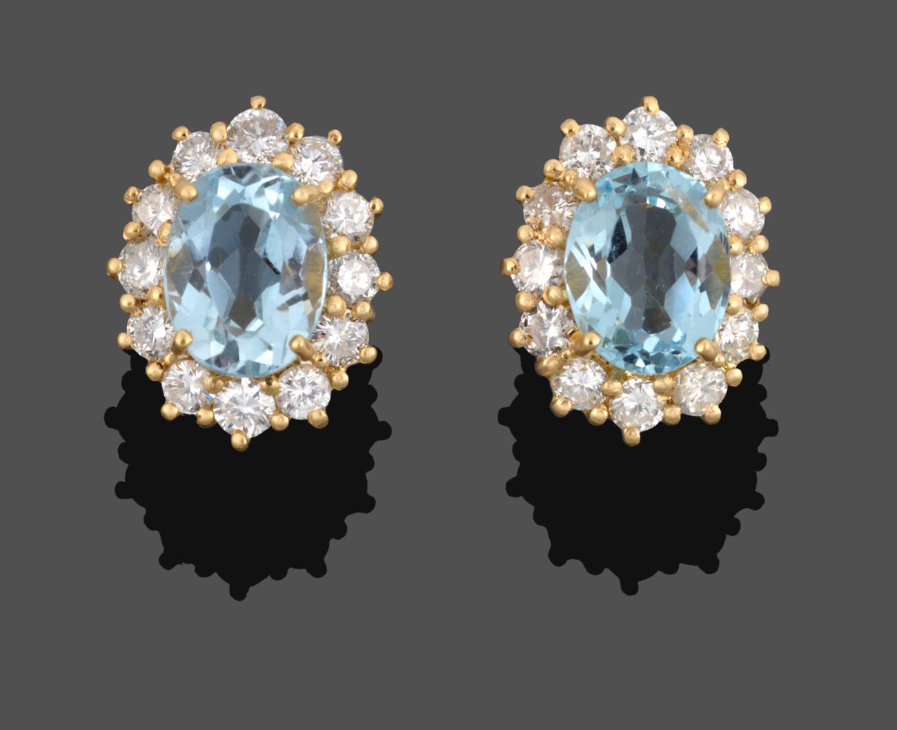 Lot 1019 - A Pair of 18 Carat Gold Aquamarine and Diamond Cluster Earrings, the oval cut aquamarines...