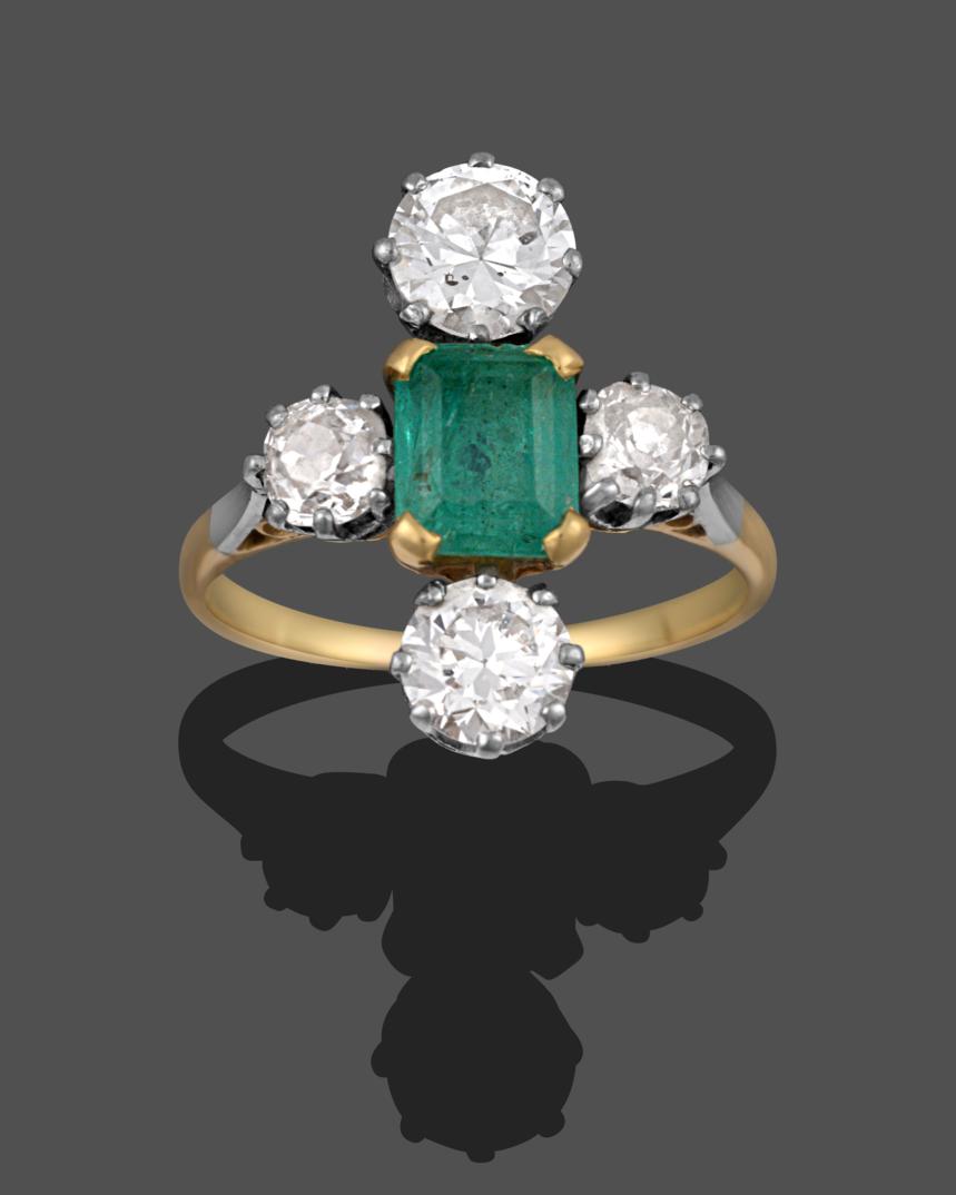 Lot 1024 - An Emerald and Diamond Ring, the emerald-cut emerald in yellow claws, flanked by an old cut diamond