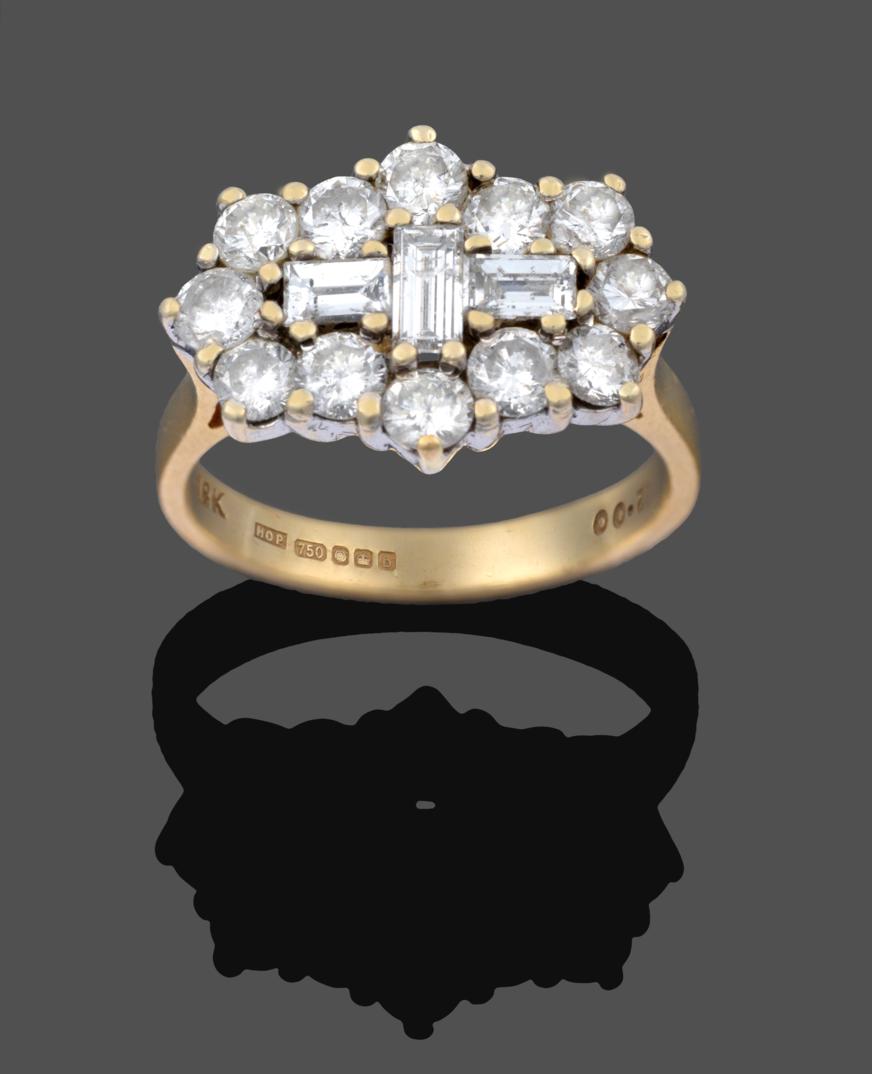 Lot 1033 - An 18 Carat Gold Diamond Cluster Ring, three baguette cut diamonds set centrally within a border of