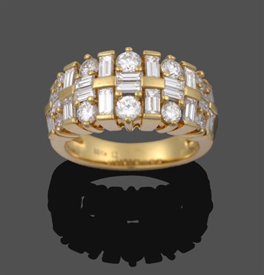 Lot 1042 - A Diamond Ring, pairs of graduated baguette cut diamonds running parallel to the shank spaced...