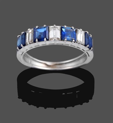 Lot 1049 - A Sapphire and Diamond Seven Stone Ring, four step cut sapphires alternate with three baguette...