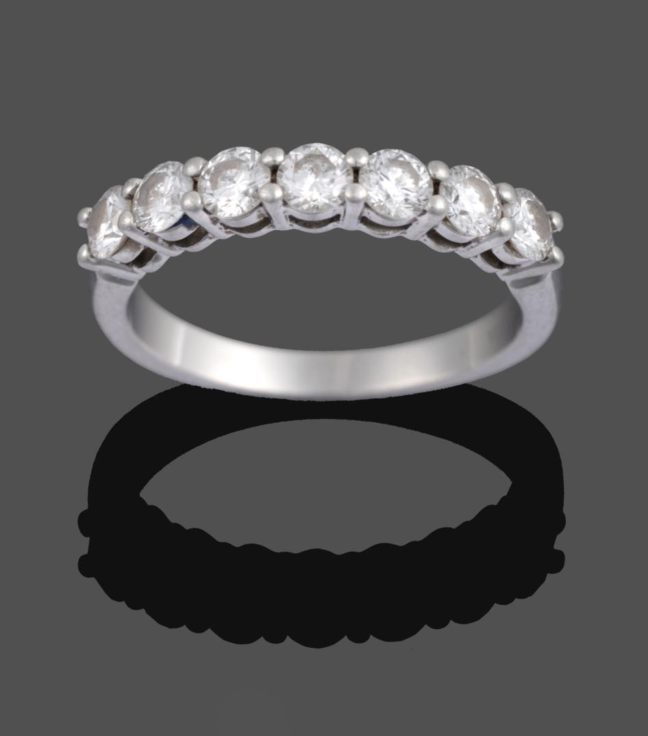 Lot 1051 - A Diamond Seven Stone Ring, by Tiffany & Co., the round brilliant cut diamonds in white claw...