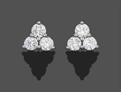 Lot 1053 - A Pair of 18 Carat White Gold Diamond Cluster Earrings, trios of round brilliant cut diamonds...
