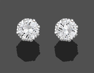 Lot 1057 - A Pair of Diamond Solitaire Earrings, the round brilliant cut diamonds in a white claw setting,...