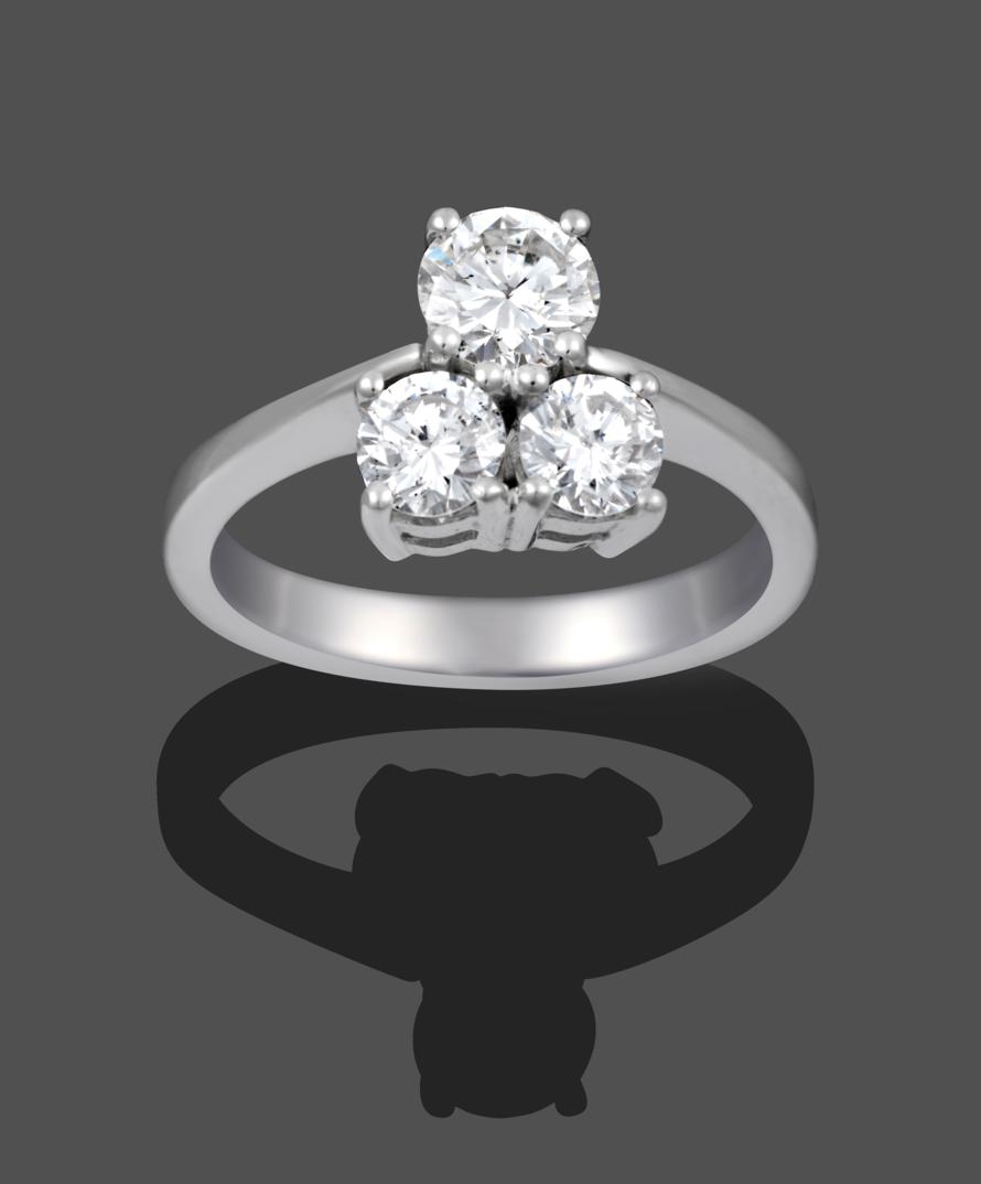 Lot 1061 - A Diamond Three Stone Ring, the graduated round brilliant cut diamonds in a trefoil formation...