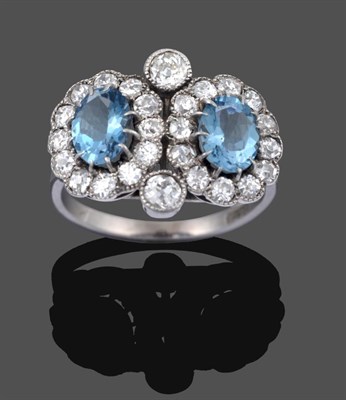 Lot 1067 - An Aquamarine and Diamond Double Cluster Ring, two oval cut aquamarines in white claw settings...