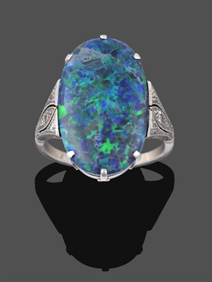 Lot 1069 - An Art Deco Black Opal and Diamond Ring, the oval black opal in a white claw setting, to beaded...