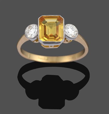 Lot 1096 - A Yellow Sapphire and Diamond Three Stone Ring, the emerald-cut yellow sapphire sits between...