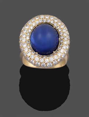 Lot 1100 - A Sapphire and Diamond Ring, by Grima, an oval cabochon sapphire in a yellow claw setting, within a