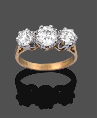 Lot 1108 - An 18 Carat Gold Diamond Three Stone Ring, the graduated old cut diamonds in white claw...