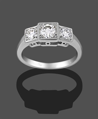 Lot 1115 - A Diamond Three Stone Ring, the graduated round brilliant cut diamonds in white claw and millegrain