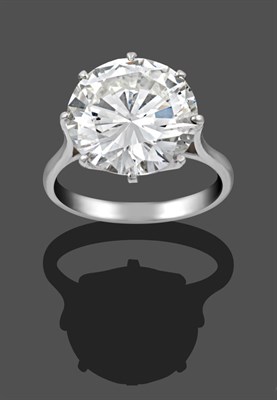 Lot 1118 - A Diamond Solitaire Ring, the round brilliant cut diamond in a white claw setting, to a tapered...