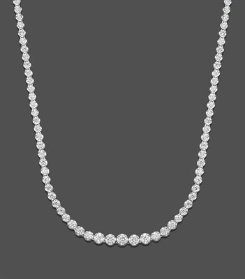 Lot 1125 - An 18 Carat White Gold Diamond Rivière Necklace, the graduated round brilliant cut diamonds in...