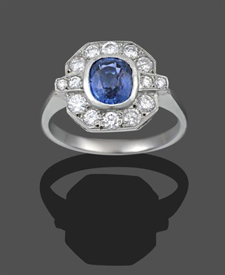 Lot 1133 - An Art Deco Style Sapphire and Diamond Cluster Ring, the cushion cut sapphire in a white millegrain