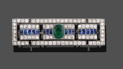 Lot 1142 - An Art Deco Diamond, Sapphire and Emerald Brooch, the oblong panel formed of three sections to...