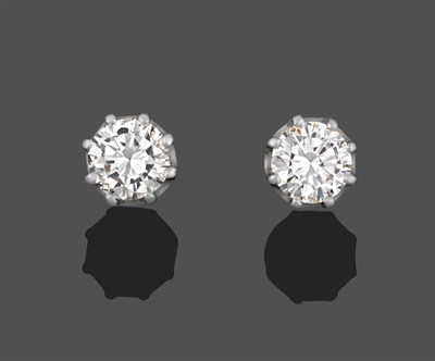 Lot 1150 - A Pair of Diamond Solitaire Earrings, the round brilliant cut diamonds in white claw settings,...