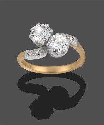 Lot 1155 - A Diamond Two Stone Twist Ring, the two round brilliant cut diamonds to eight-cut diamond set...