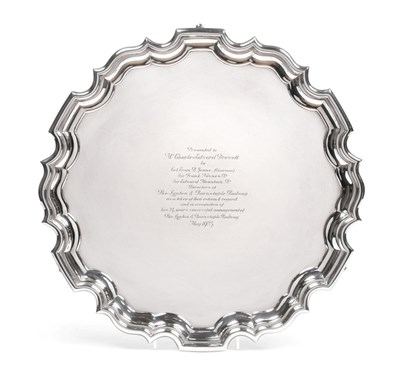 Lot 1241 - A George V Silver Salver, by Carrington and Co, London, 1922, shaped circular and on three pad...