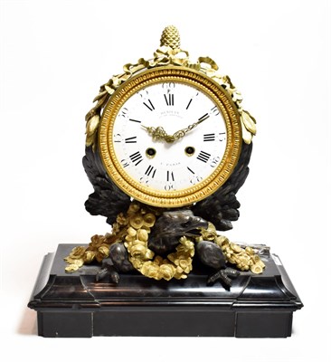 Lot 13 - A French gilt metal and bronze striking mantel clock, as an eagle on a black slate base, the enamel
