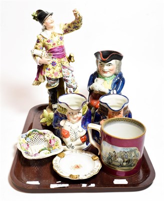 Lot 27 - A German porcelain figure of a drunken soldier together with three Toby jugs and other ceramics...