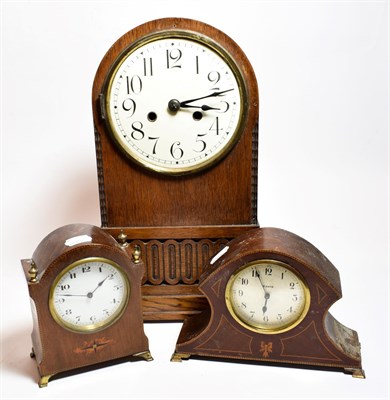 Lot 33 - An enamelled dialled Oak Mantle clock circa 1920, two Edwardian inlaid mantle clocks (3)