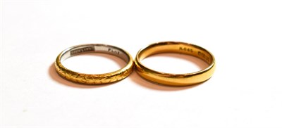 Lot 45 - A 22 carat gold band ring, finger size O; and a two colour band ring, stamped 'PLAT' and...