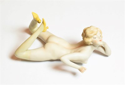 Lot 89 - An early 20th century German bisque figure of a nude young woman, unmarked, modelled lying on front