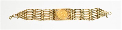 Lot 96 - A 1927 sovereign bracelet, the sovereign placed centrally within a scroll mount to a gate link...