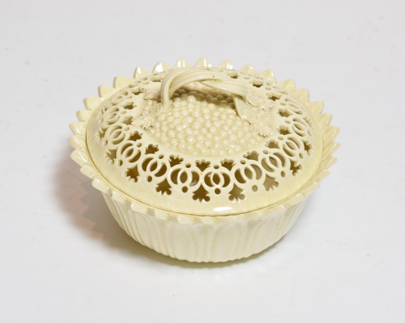 Lot 187 - A Leeds pottery reticulated creamware bowl and cover, strap work handle, stamped