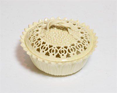 Lot 187 - A Leeds pottery reticulated creamware bowl and cover, strap work handle, stamped
