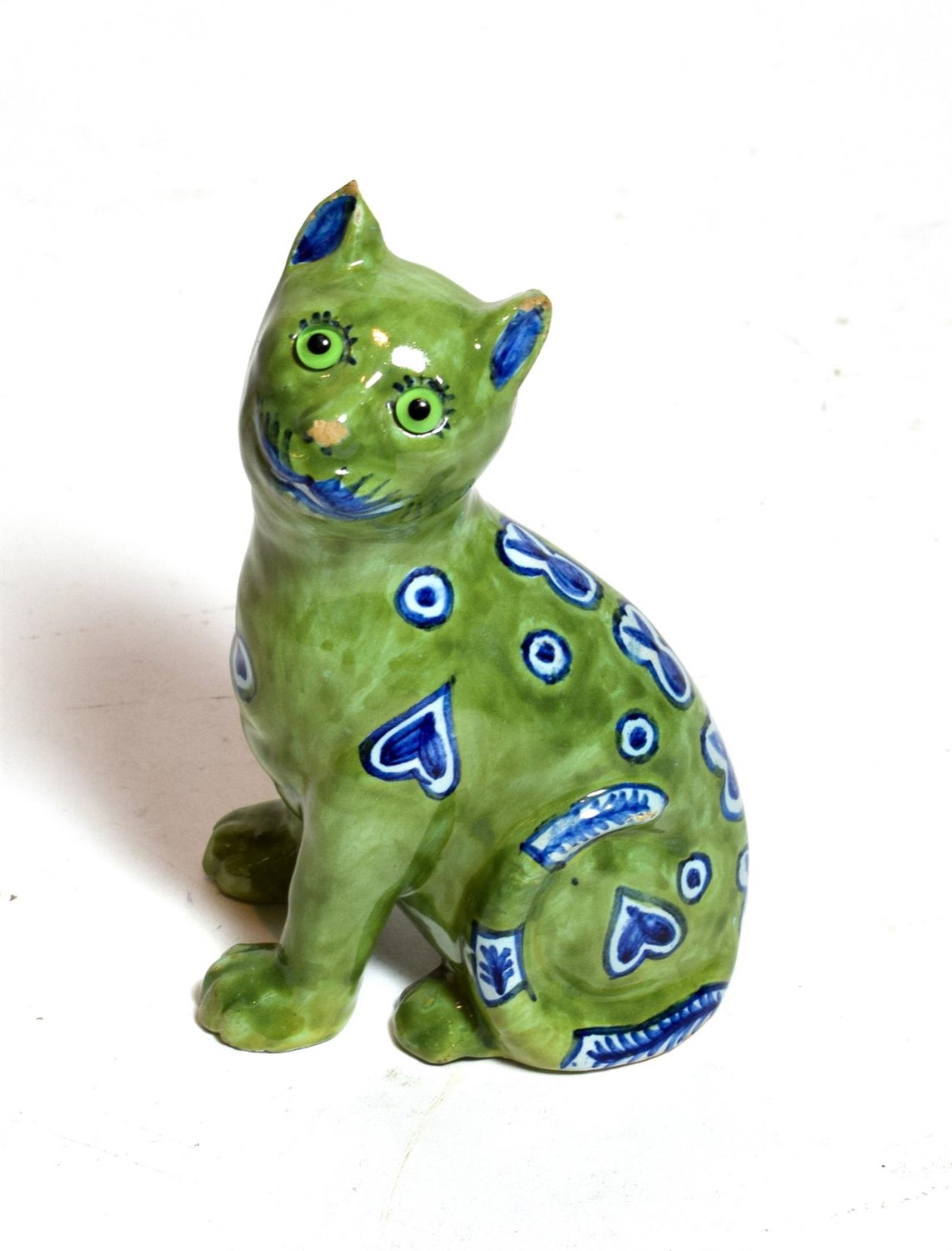 Lot 210 - A Mosanic faience pottery cat, circa 1900, modelled seated with blue hearts, on a green ground,...