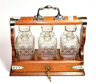 Lot 249 - A silver plated three bottle tantalus